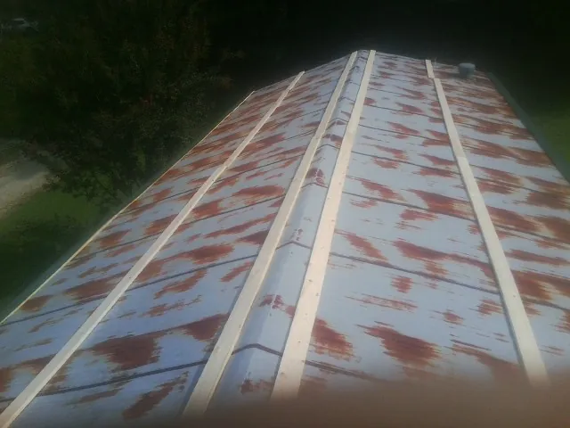 Rusted metal roof panels with new wood purlins before replacement — Storm Damage Roof Repair in Sandgap by Roofing Brothers
